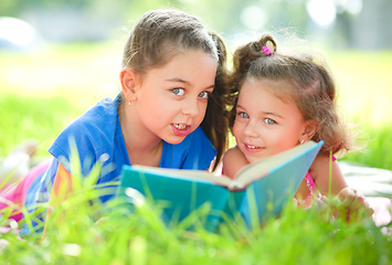 Image showing Two little girls are reading book