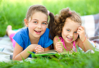 Image showing Two little girls are reading book