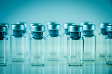 Image showing Vaccine glass bottles on blue background