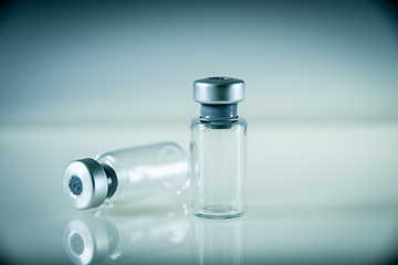 Image showing two vaccine bottles on grey background