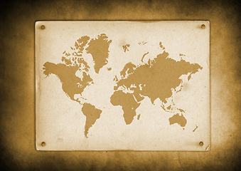 Image showing Vintage world map parchment nailed to a wall