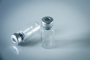 Image showing two vaccine bottles on grey background