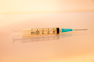 Image showing Syringe on orange background