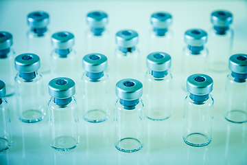 Image showing Vaccine glass bottles on blue background