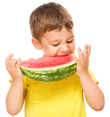 Image showing Little boy is eating watermelon