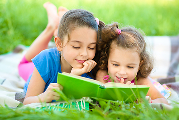 Image showing Two little girls are reading book