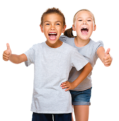 Image showing Little boy and girl are showing thumb up sign