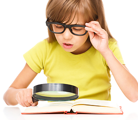 Image showing Little girl is reading book