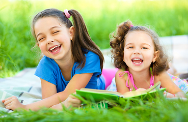 Image showing Two little girls are reading book