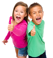 Image showing Little boy and girl are showing thumb up sign