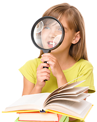 Image showing Little girl is reading book