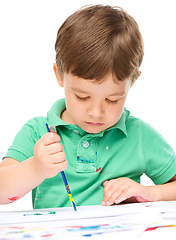 Image showing Little boy is playing with paints