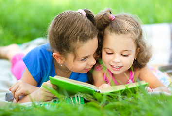 Image showing Two little girls are reading book