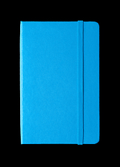 Image showing Cyan blue closed notebook isolated on black