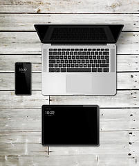 Image showing Laptop, tablet and phone set mockup on a wooden background. 3D r