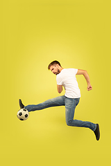 Image showing Full length portrait of happy jumping man on yellow background