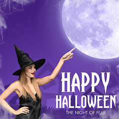 Image showing Young woman in hat as a witch on purple background