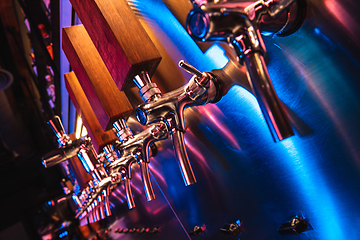 Image showing Beer pouring machine in modern neon lights