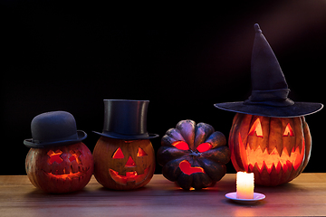 Image showing Halloween pumpkin head jack lantern with scary evil faces and candles