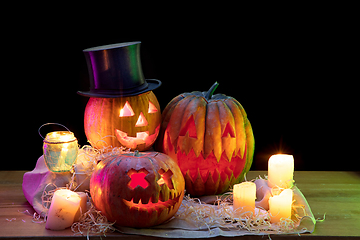 Image showing Halloween pumpkin head jack lantern with scary evil faces and candles