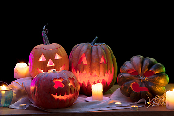 Image showing Halloween pumpkin head jack lantern with scary evil faces and candles