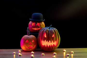 Image showing Halloween pumpkin head jack lantern with scary evil faces and candles