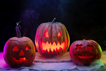 Image showing Halloween pumpkin head jack lantern with scary evil faces and candles