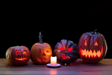 Image showing Halloween pumpkin head jack lantern with scary evil faces and candles