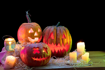 Image showing Halloween pumpkin head jack lantern with scary evil faces and candles