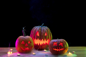 Image showing Halloween pumpkin head jack lantern with scary evil faces and candles