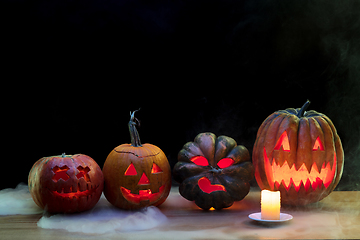 Image showing Halloween pumpkin head jack lantern with scary evil faces and candles