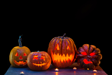 Image showing Halloween pumpkin head jack lantern with scary evil faces and candles