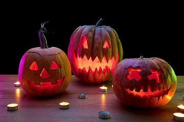 Image showing Halloween pumpkin head jack lantern with scary evil faces and candles