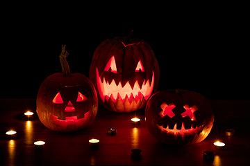 Image showing Halloween pumpkin head jack lantern with scary evil faces and candles