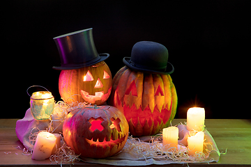 Image showing Halloween pumpkin head jack lantern with scary evil faces and candles