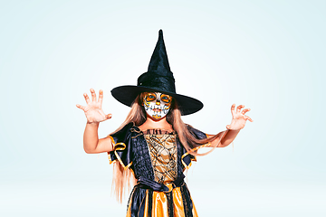 Image showing Little girl like a witch on white background