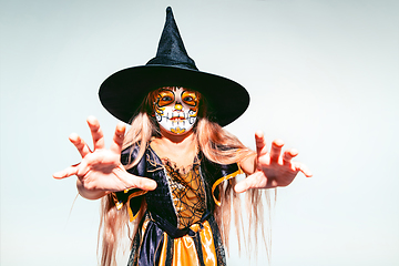 Image showing Little girl like a witch on white background