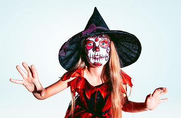 Image showing Little girl like a witch on white background