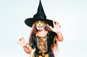 Image showing Little girl like a witch on white background