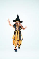 Image showing Little girl like a witch on white background