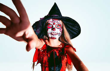 Image showing Little girl like a witch on white background