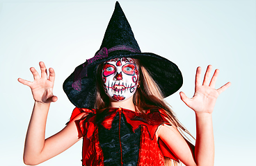 Image showing Little girl like a witch on white background