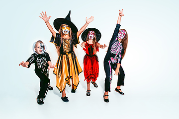 Image showing Kids or teens like witches and vampires on white background