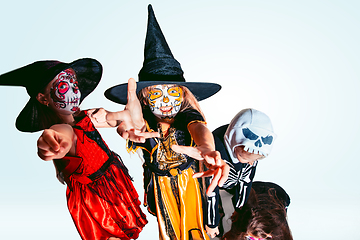 Image showing Kids or teens like witches and vampires on white background