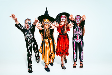 Image showing Kids or teens like witches and vampires on white background