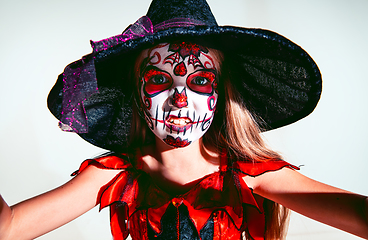 Image showing Little girl like a witch on white background