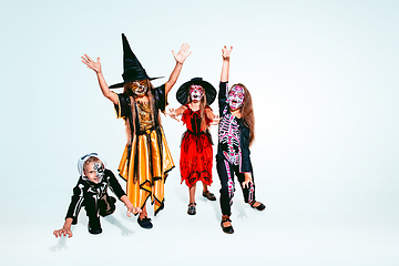 Image showing Kids or teens like witches and vampires on white background