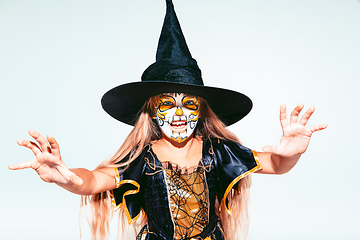 Image showing Little girl like a witch on white background