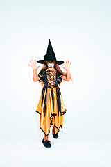 Image showing Little girl like a witch on white background