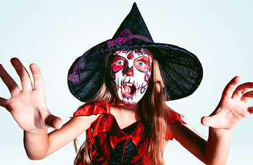 Image showing Little girl like a witch on white background